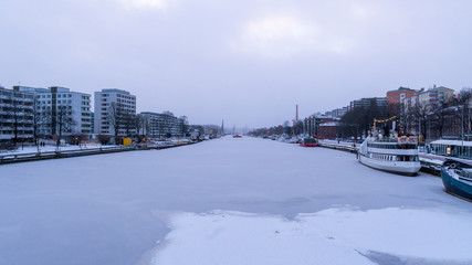 City of Turku and Aurajoki river scenery in a misty snow rain. January 2019.
