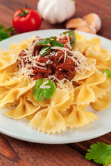 Pasta with meat, tomato sauce and vegetables on the table