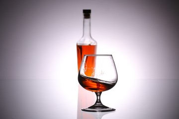 glasses and bottles for brandy and wine in the background