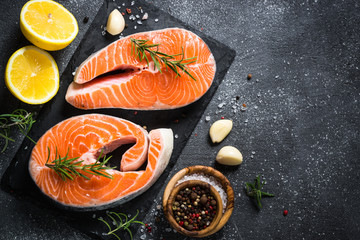 Salmon fish steak with spices on black.