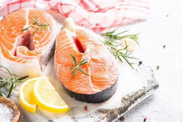 Fresh fish Salmon steak with spices on cutting board.