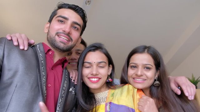 Two beautiful couples posing as friends and lovers for their photo video selfie pov with smiles together 