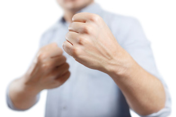 Obraz premium Man raised his fists ready to fight, isolated on white background