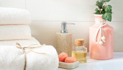 Fototapeta na wymiar Shower objects, clean towels,soap and oil in bathroom.