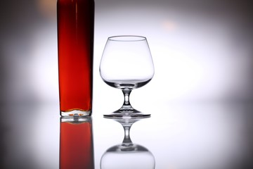 glasses and bottles for brandy and wine in the background