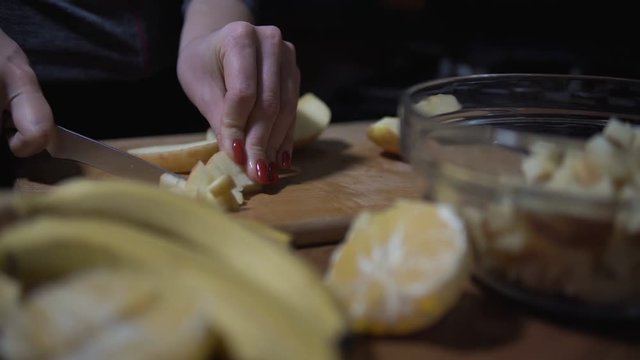 housewife at home preparing fresh salad slicing apple fruits on cutting board. vegetarian healthy food and dieting concept. 4K
