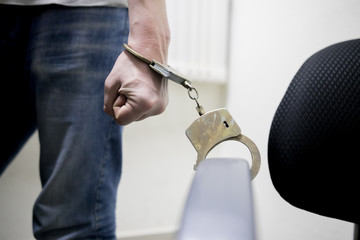 imprisoned man with handcuffs on his hands