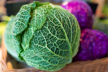 Savoy cabbage super food close up, on farmer market, against the background purple cabbage