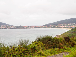 Naklejka na ściany i meble First sight of Finisterre and the Shrimp Beach Praiade Langosteira on an overcast day in autumn - Sardineiro, Galicia, Spain