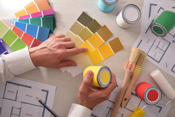 Decorator choosing a color for interior housing project top