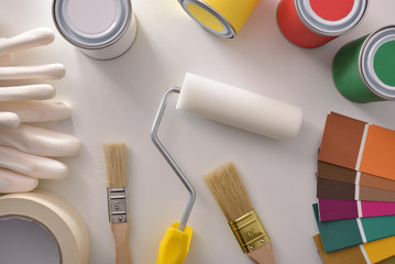 Tools for painting houses on white table general view top