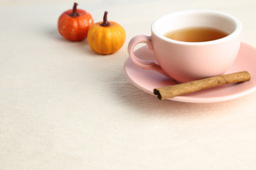 Obraz na płótnie Canvas Hot black tea cup on beige fabric background