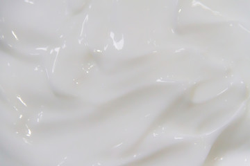 The white surface of the cream lotion softens the background.