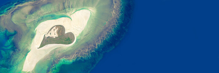 Aerial view of an island in the shape of a heart - Elements of this image are furnished by NASA