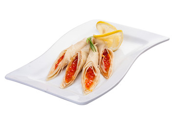 Pancakes with red caviar. On white background.