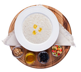 Oatmeal with candied fruits and raisins. Top view on white background