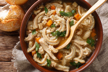 Flaki or flaczki is a traditional Polish meat stew close-up in a bowl served with bread. horizontal...