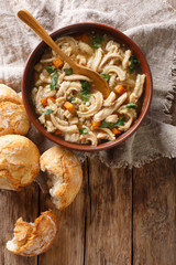 Polish stew flaki with vegetables close-up in a bowl. Vertical top view