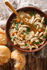 Polish homemade meal stew flaczki with vegetables close-up in a bowl. Vertical top view