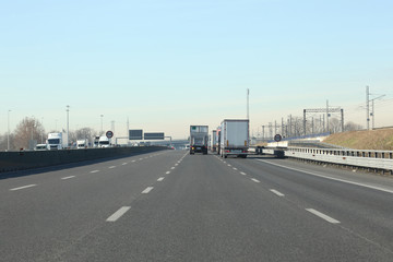 Fototapeta na wymiar lanes with cars and trucks on italian highway