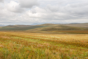 Mongolian steppe on the background of a cloudy sky
