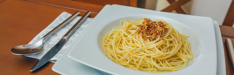 Spaghetti with worms dish placed on the table ready to eat
