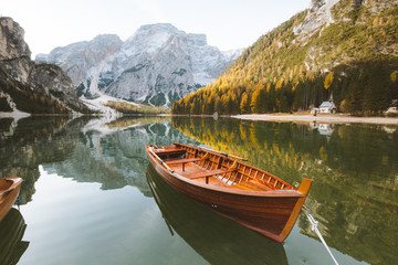 Wooden rowing boat on alpine lake in fall