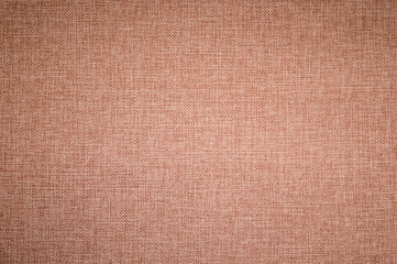 Fototapeta premium Textured background surface of textile upholstery furniture close-up. burlap brown color fabric structure
