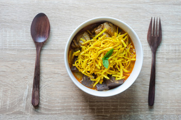 Khao soi - Traditional Thai Food, Khao Soi Thai Noodle Curry Soup with chicken on wood table, Khao soi a famous northern Thai food
