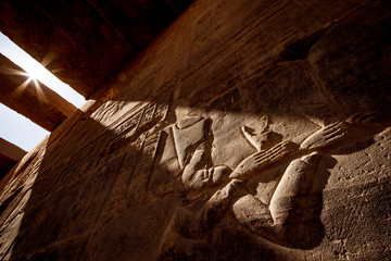 Ancient Egyptian hieroglyphs in sunset light at Aswan Temple Philae in Egypt