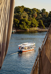Naklejka premium Nile river tourist boat at sunset in Luxor Egypt