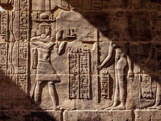 Egyptian hieroglyphs at Philae Temple in Aswan in sunset light
