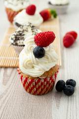 Decorated cupcakes on a wooden table.
