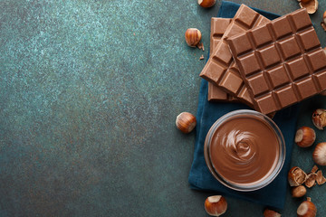 Chocolate spread with hazelnuts on blue green countertop