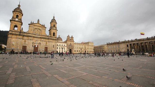 BOGOTA, COLOMBIA - JUNE 14: Unidentified people walk past the Archbishopric Cathedral of Bogota and the Capitolia Nacional in Bogota, Colombia on June 16, 2016.