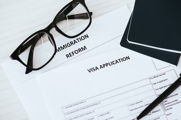 documents with lettering near glasses and passports