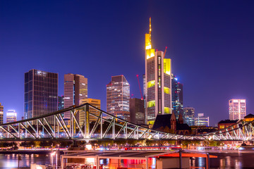 Skyline cityscape of Frankfurt, Germany during twilight evening with a bridge. Frankfurt Main in a financial capital of Europe.