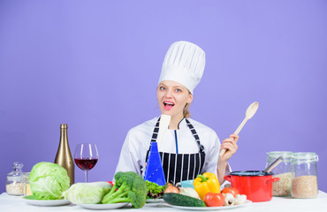 Cooking healthy food. Girl in hat and apron. Woman chef cooking healthy food. Fresh vegetables ingredients for cooking meal. Delicious recipe concept. Gourmet main dish recipes. Cooking is her hobby