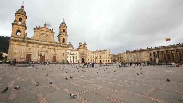 BOGOTA, COLOMBIA - JUNE 14: Unidentified people walk past the Archbishopric Cathedral of Bogota and the Capitolia Nacional in Bogota, Colombia on June 16, 2016.