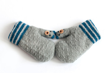 Pair of grey knitted mittens on white background