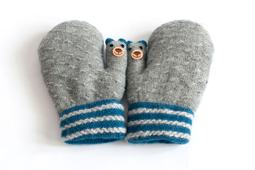 Pair of grey knitted mittens on white background