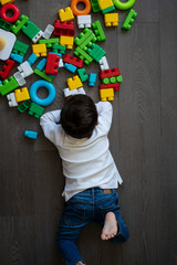 Happy baby playing with toy blocks.