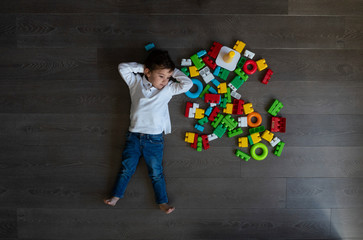 Happy baby playing with toy blocks.