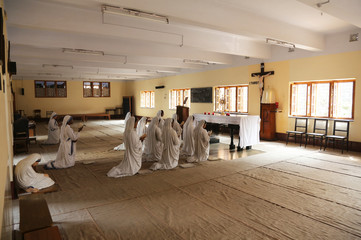 Sisters of Mother Teresa's Missionaries of Charity in prayer in the chapel of the Mother House, Kolkata, India 