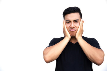 Fototapeta premium Portrait of a young latin handsome man touching his face with hands.