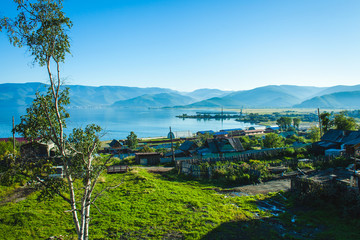 view on a russian siberian village on the coast of the Baikal lake by sunny summer day