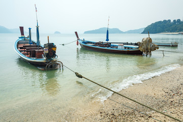 traditional thai motor boats in a bay of Phuket island in Thailand