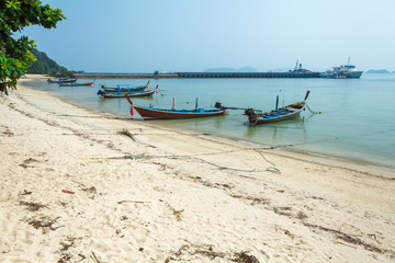 Fototapeta na wymiar traditional thai motor boats in a bay of Phuket island in Thailand