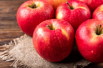 Red apples on dark wooden background.