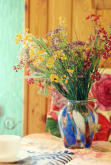 still life on a table of autumn flowers, fruits and coffee